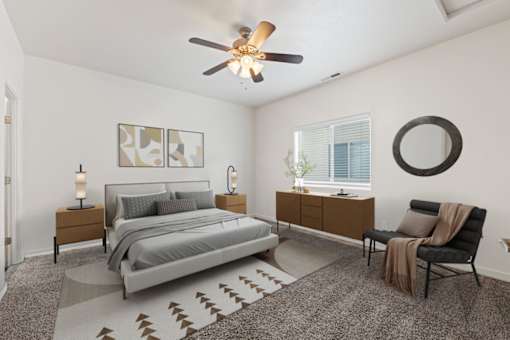 A bedroom with a bed, chair, and a rug. at Verraso Village Apartments, Meridian 83646