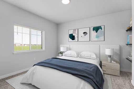 A bedroom with a large bed and a window with blinds.