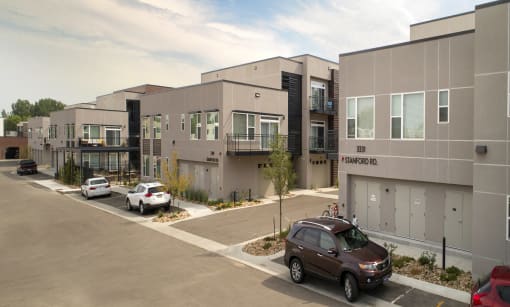 a view of a building with cars parked in front of it at Cycle Apartments, Fort Collins, CO