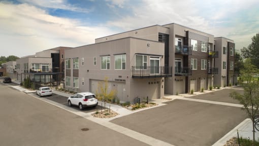 a new apartment building with cars parked in front of it at Cycle Apartments, Fort Collins