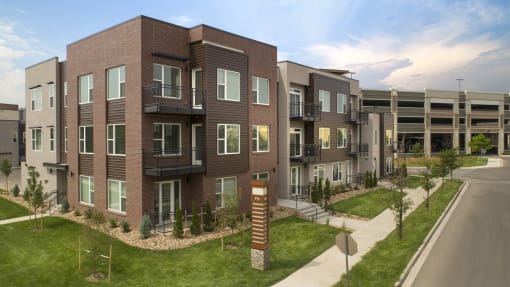 a rendering of an apartment building on a city street at Cycle Apartments, Fort Collins, CO, 80525