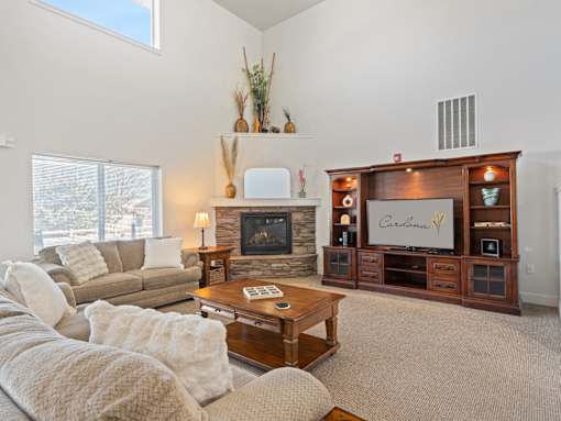 A living room with a fireplace and a flat screen TV.