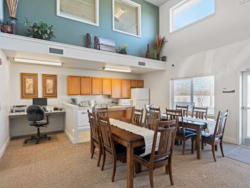 A dining room with a table set for six.
