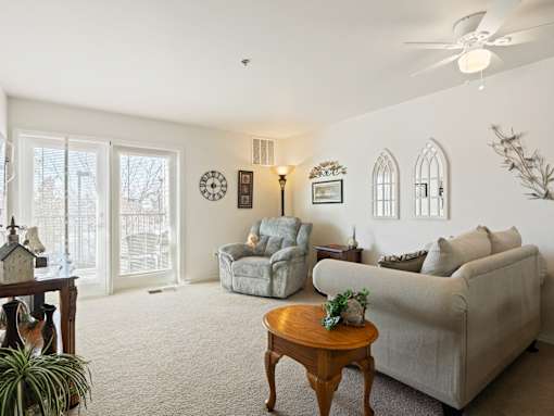 A living room with a couch, chair, and a table.