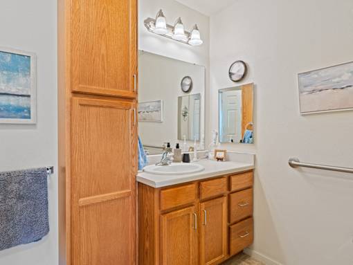 A bathroom with a wooden door and a white sink.