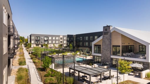 a rendering of a building with a pool and patio area with tables