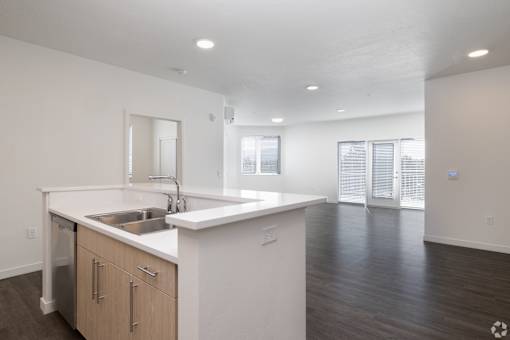 A kitchen with a sink and a counter.