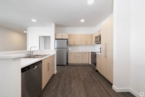 A kitchen with wooden floors and white walls.