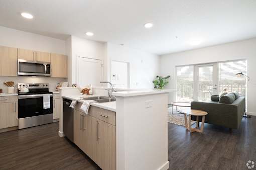 A modern kitchen with wooden cabinets and a white island.