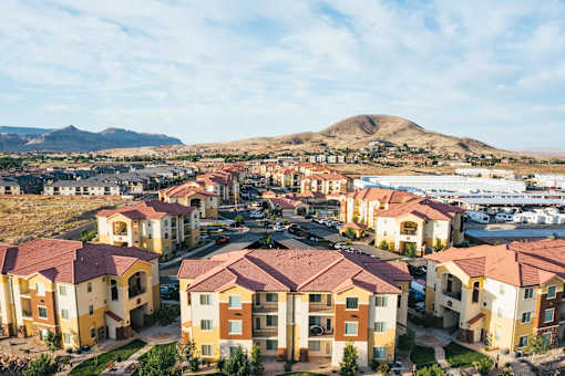 A large housing development with a mountain in the background.