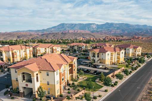 A row of houses with a mountain in the background.