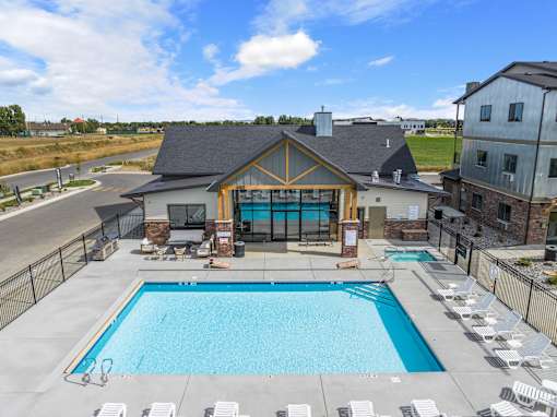 A large outdoor swimming pool with lounge chairs at The Expo in Billings, MT,