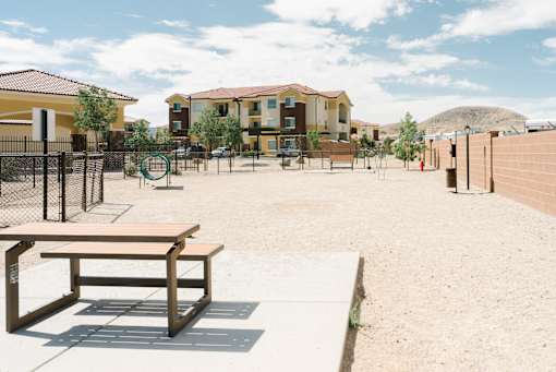 A playground with a bench and a basketball hoop.