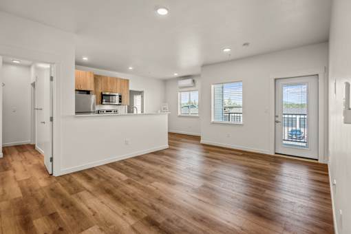 A spacious kitchen with wooden floors and white walls at Silverbrook Apartments, Kalispell, Montana 59901