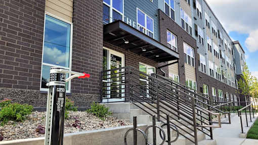 A building with a red arrow pointing to a door.