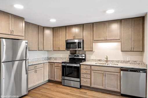 A kitchen with wooden cabinets and stainless steel appliances.