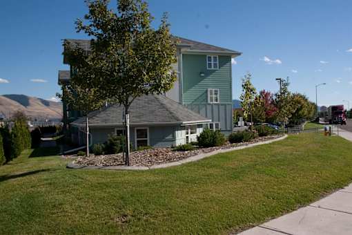 green house with tree in front at Great Northern, Montana, 59808