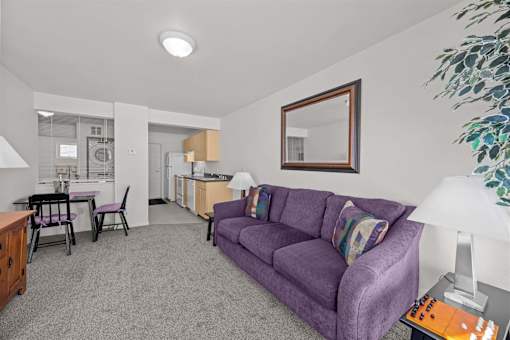 room with a purple couch and mirror on the wall at Great Northern, Missoula
