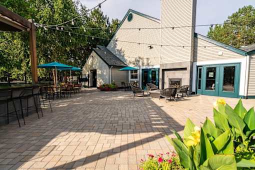 Outdoor patio with brick flooring and string lights at Edgewater Apartments, Boise, Idaho
