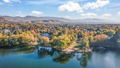 Aerial view of lakeside residential area with autumn trees at Edgewater Apartments, Idaho