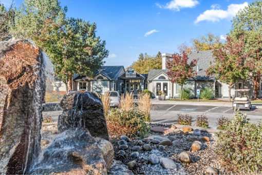 Property entrance with decorative rock water feature at Edgewater Apartments, Idaho, 83703