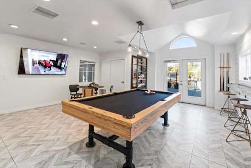 Game room with pool table and mounted television at Edgewater Apartments, Boise, ID 83703