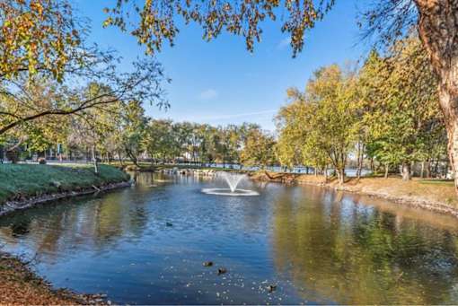 Park pond with fountain and autumn trees at Edgewater Apartments, Idaho