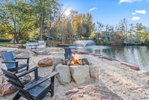 Lakeside fire pit area with adirondack chairs at Edgewater Apartments, Boise, 83703