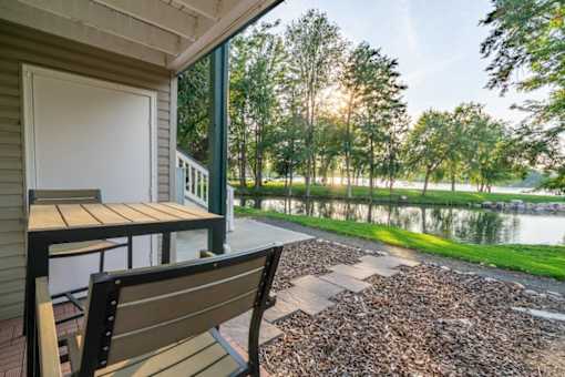 Covered deck overlooking pond with outdoor furniture at Edgewater Apartments, Boise, ID 83703