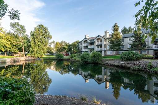 Pond with apartment buildings and mature landscaping at Edgewater Apartments, Idaho, 83703