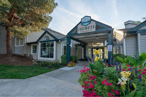 Leasing office entrance with colorful flower gardens at Edgewater Apartments, Boise, ID