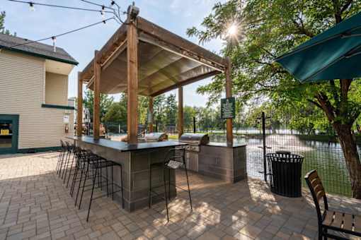 Outdoor grilling station with covered dining area at Edgewater Apartments, Boise, Idaho
