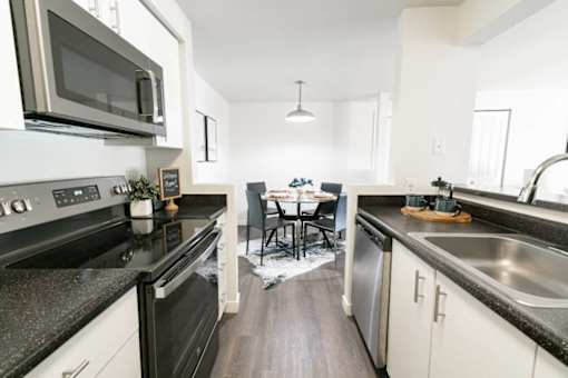 Modern galley kitchen with stainless steel appliances at Edgewater Apartments, Idaho, 83703