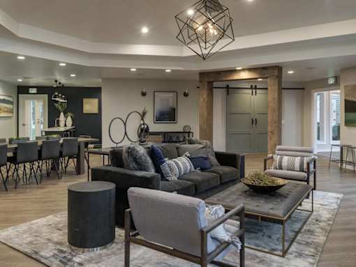 Modern living room with gray sectional sofa at Edgewater Apartments, Boise, ID 83703