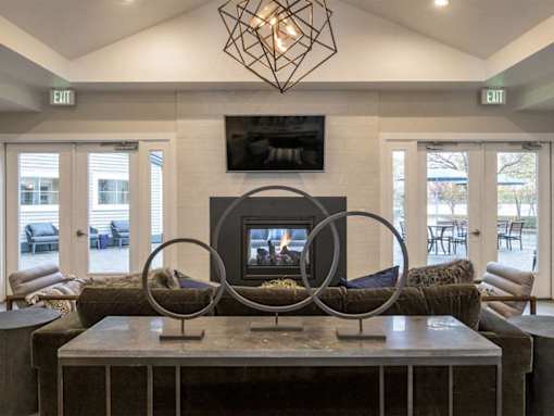 Community lounge with fireplace and modern seating at Edgewater Apartments, Boise, 83703