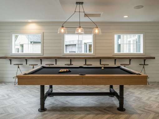 Recreation room with pool table and bar seating at Edgewater Apartments, Boise, Idaho