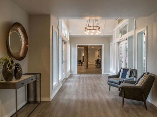 Sunroom seating area with large windows at Edgewater Apartments, Boise