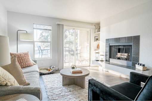 Living room with fireplace and patio access at Edgewater Apartments, Boise, 83703