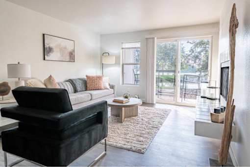 Modern living room with sectional sofa and patio access at Edgewater Apartments, Idaho