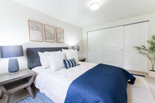 Bedroom with blue accents and builtin closet at Edgewater Apartments, Boise, ID