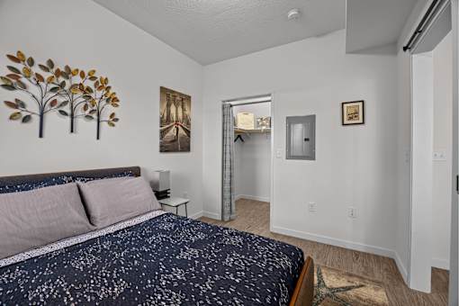 A bedroom with a bed and a painting at Majestic Drive, Montana