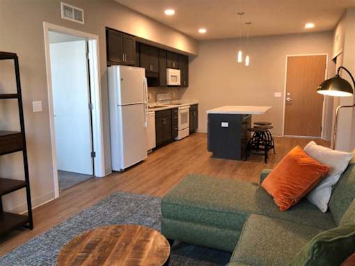 Open-concept 1-3 bedroom interior at Morrow Apartments in St. Paul, MN with a kitchen island and modern finishes.