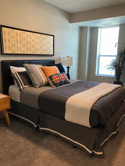 A small room with a bed and a window.