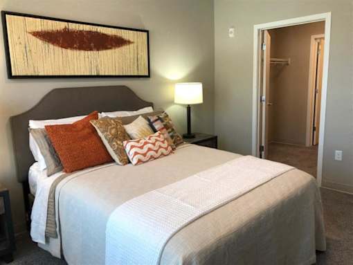 Modern bedroom with a walk-in closet at Morrow Apartments in St. Paul, MN, near the Green Line.