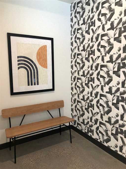 A picture of a framed artwork is hanging on a wall.