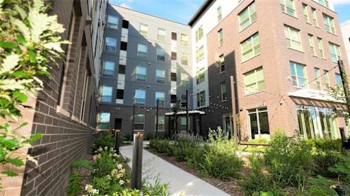 A modern building with a garden in front.