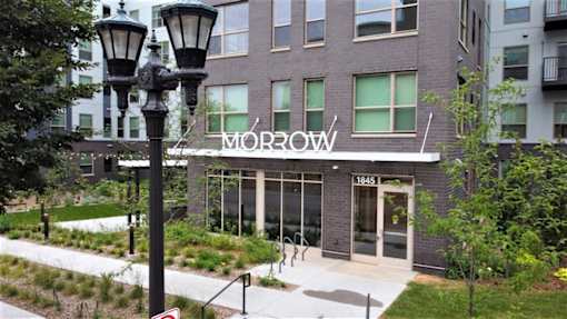 A street lamp stands in front of a building with the word 