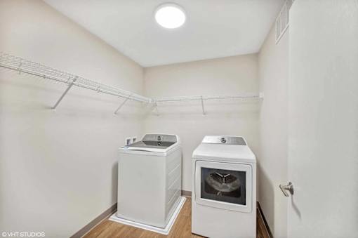 A small kitchen with a white oven and a white cabinet.