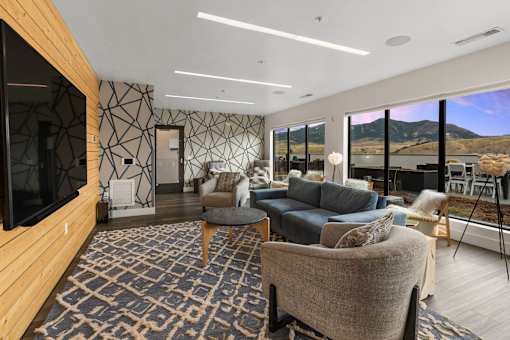 A living room with a large rug and a flat screen TV at Cannery Flats, Bozeman, Montana