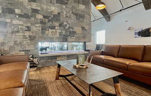 A living room with a brown leather couch and a glass coffee table at Silverbrook Apartments Apartments, Kalispell, 59901